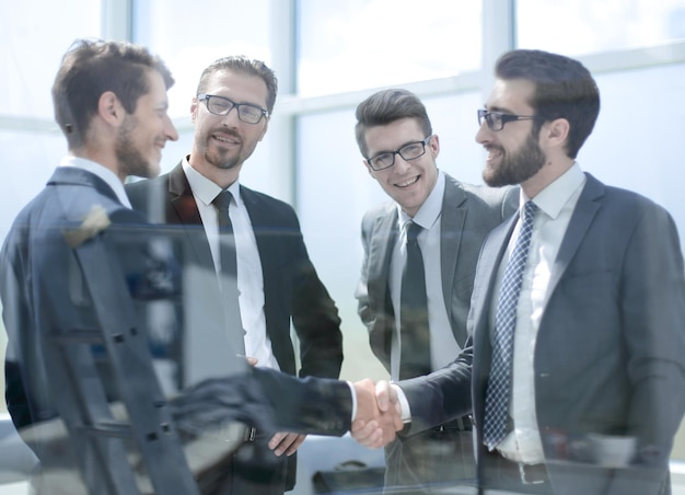 Business partners shaking hands in the lobby of the business centerbusiness concept