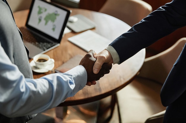 Business partners shaking hands at meeting