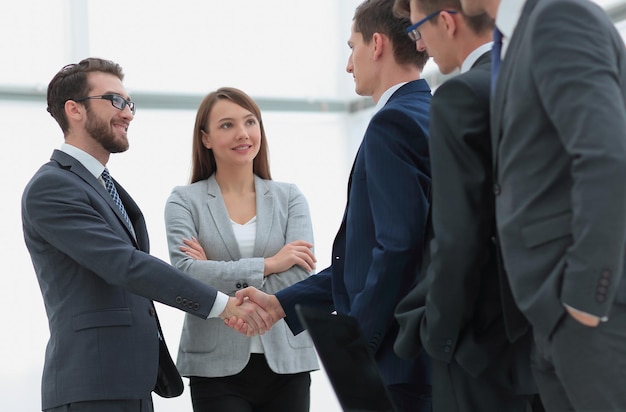 Business partners shaking hands on meeting