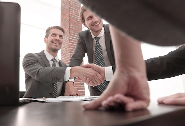 Business partners shaking hands in the office