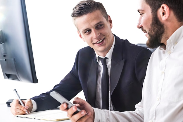 Business partners sitting near computer