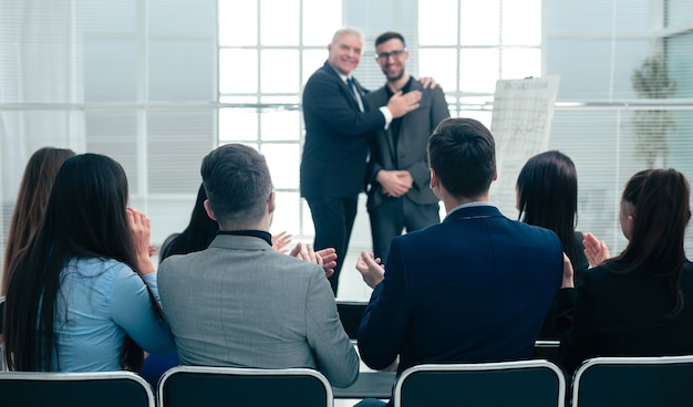 Business partners standing together in a conference room during a business meeting.