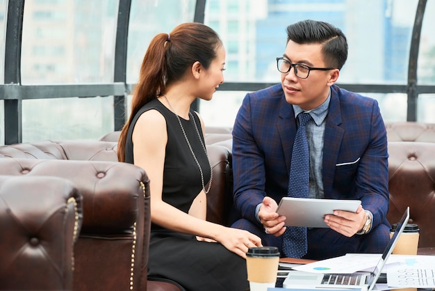 Business partners talking at office