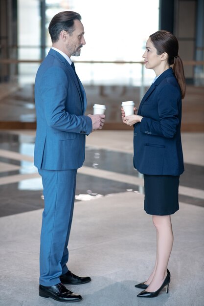 Business partners with coffees in the office