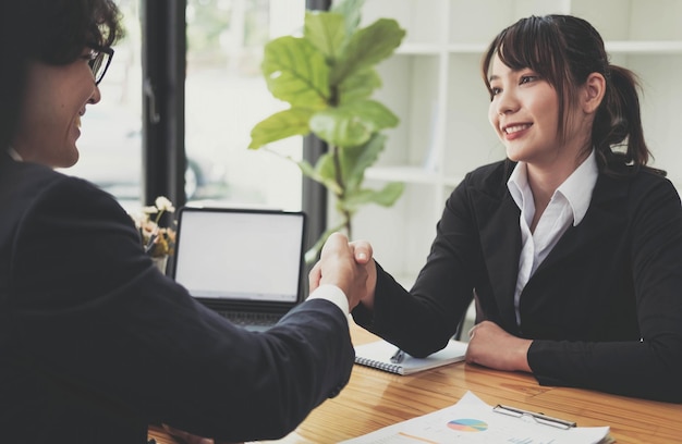 Business partnership meeting concept Image businessmans handshake Successful businessmen handshaking after good deal Group support concept