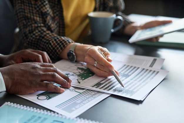 Business people analyzing report with graphs