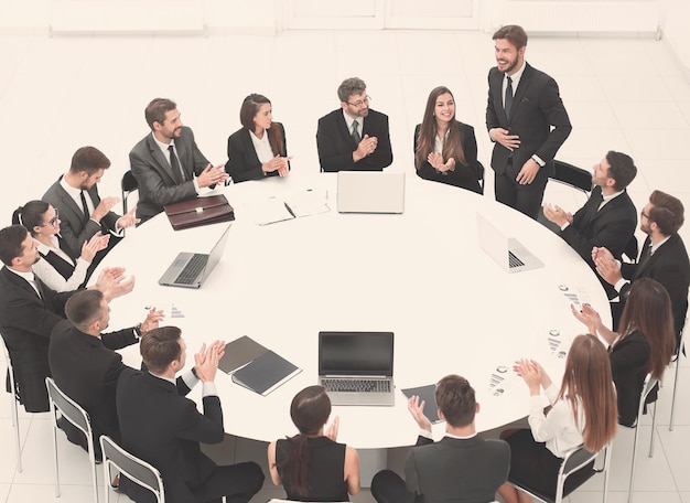 Business people applauding speaker at a business meeting