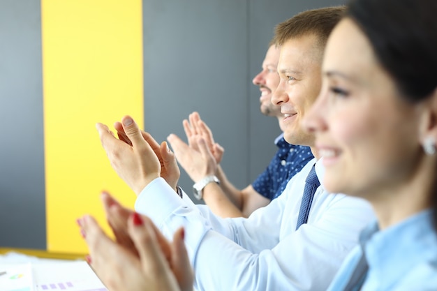 Foto gli uomini d'affari applaudono e guardano lontano