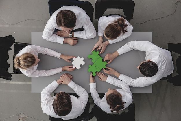 Business people assembling puzzle