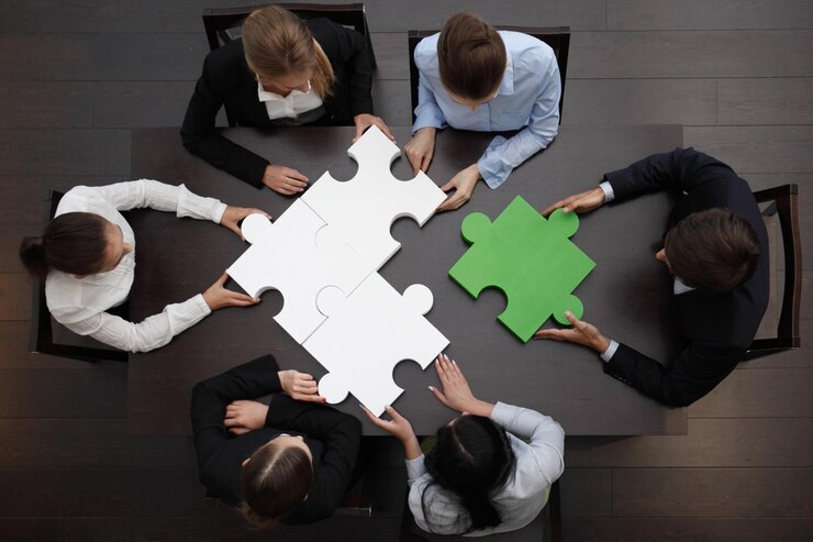 Business people assembling puzzle