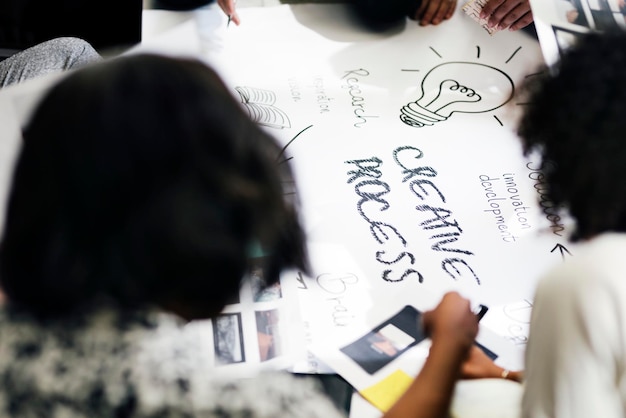 Business people brainstorming management process on paper