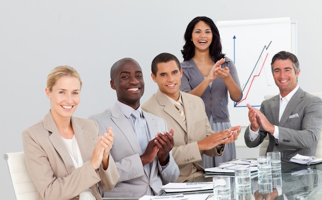 Business people clapping at a presentation