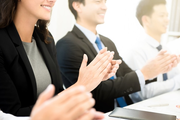 Business people  clapping their hands at the meeting