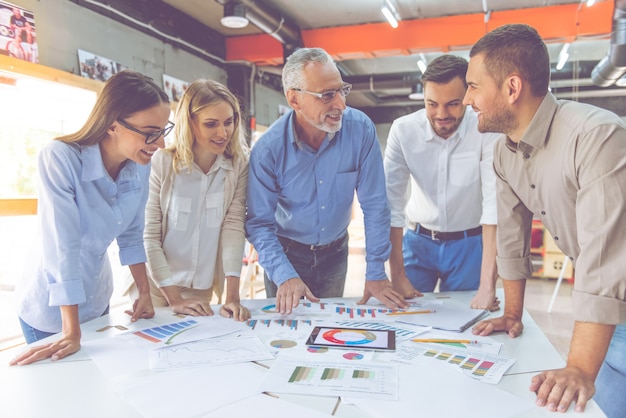 Business people in classic shirts are studying documents.