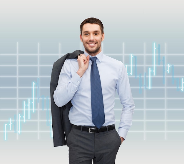 Photo business and people concept - smiling young and handsome businessman over forex chart background