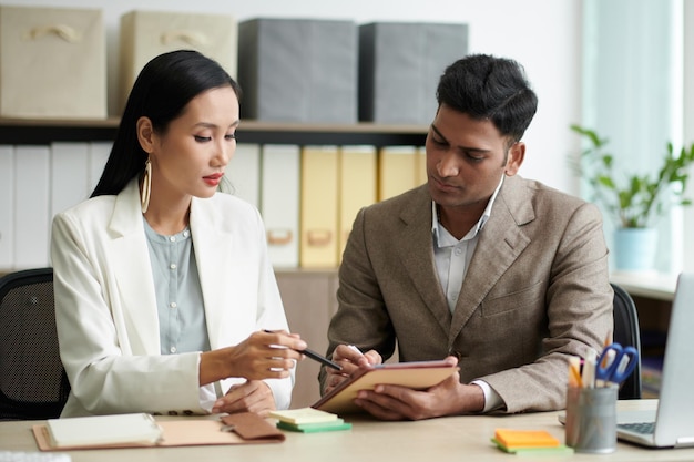 business people correcting document