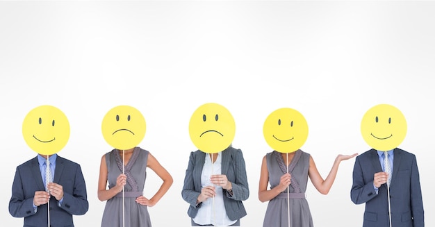 Photo business people covering faces with various smileys against white background