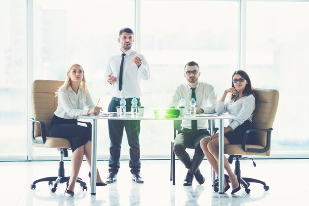 The business people discuss near the projector