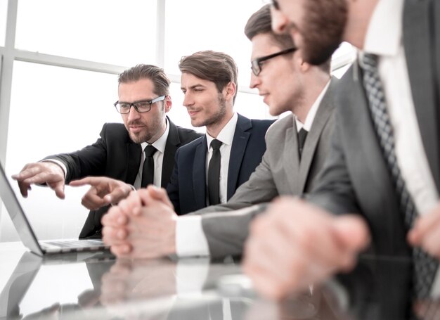 Business people discuss online information sitting at the Desk