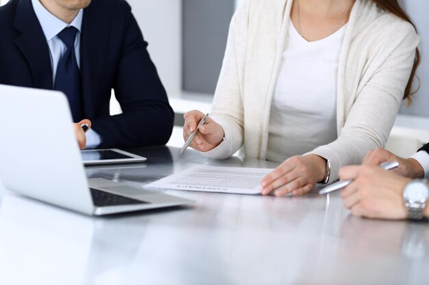 Business people discussing contract working together at meeting at the glass desk in modern office