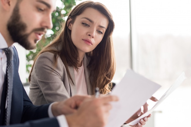 Business People Discussing Documents in Office