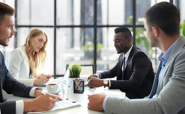 Business people in discussing something while sitting together at the table