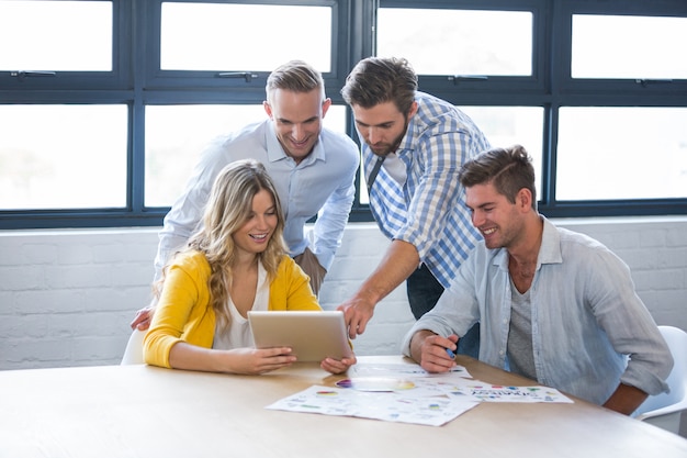 Business people discussing over tablet computer