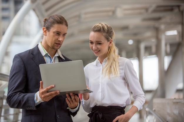 Business People Discussing While Standing On Footbridge