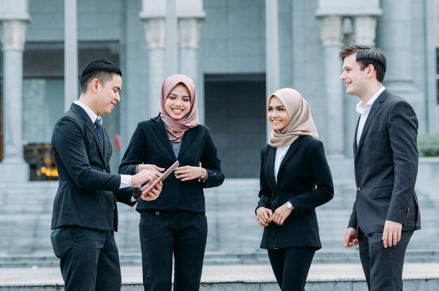 Business people discussing while standing outdoors