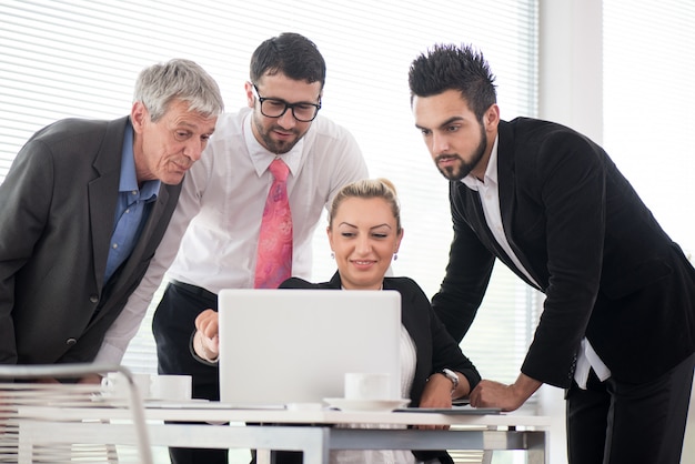 Business people and executives having meeting using laptop