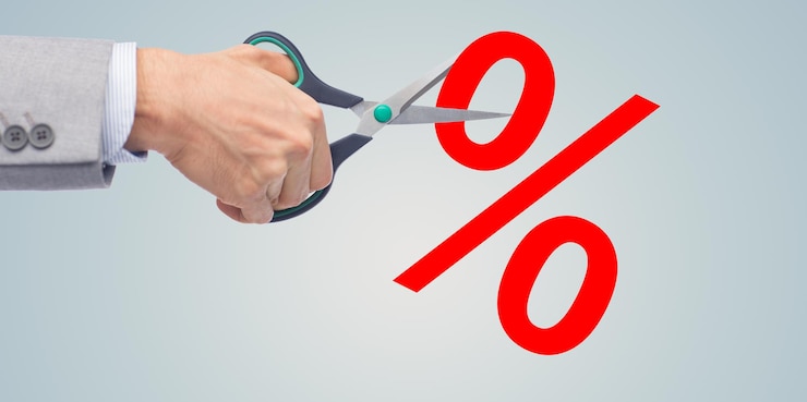 Photo business, people, financial crisis, sale and default concept - close up of businessman hand with scissors cutting percents over gray background