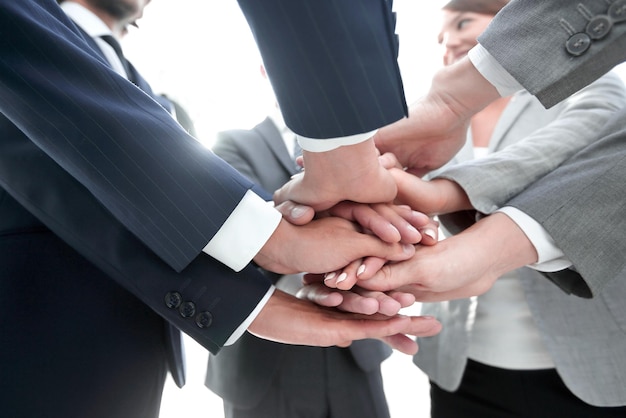 business people folding their hands together