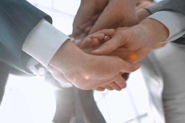 Business people folding their hands together