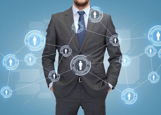 business, people and global connection concept - close up of businessman over blue world map and human icons background