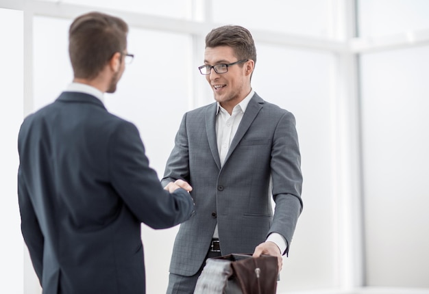 Business people greet each other with a handshakephoto with copy space