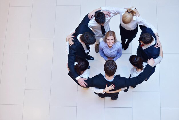 business people group joining hands and stay as team in circle  and representing concept of friendship and teamwork