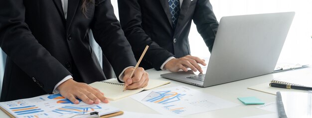 Business people in group meeting in formal attire share idea discussing report for company profit in creative workspace for start up business shot in close up view on group meeting table Oratory