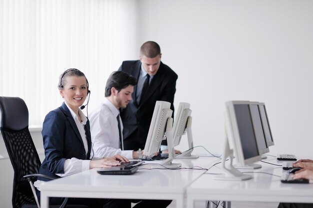 business people group with  headphones giving support in  help desk office to customers, manager giving training and education instructions