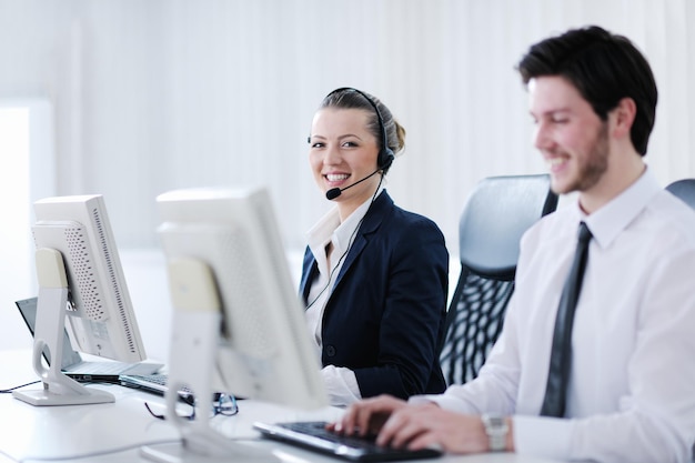 business people group with  headphones giving support in  help desk office to customers, manager giving training and education instructions