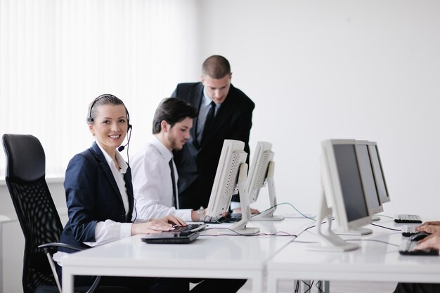 business people group with  headphones giving support in  help desk office to customers, manager giving training and education instructions