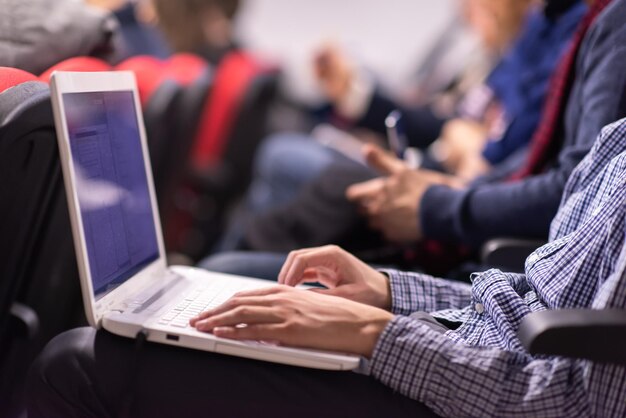 business people hands typing on laptop computer keyboard during the seminar at conference room
