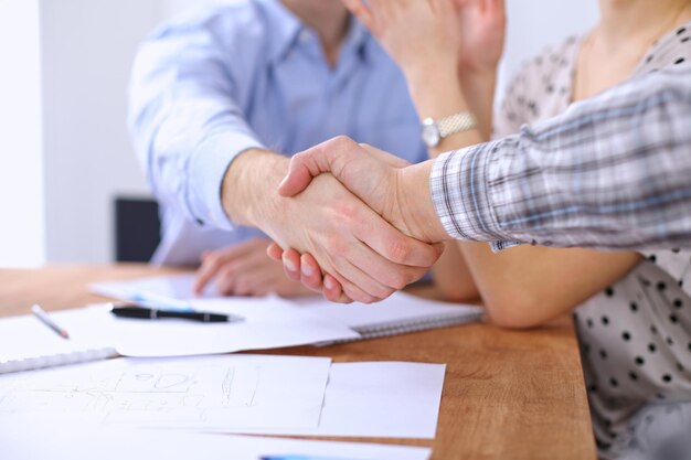 Business people handshaking finishing up meeting, close up. Start up team