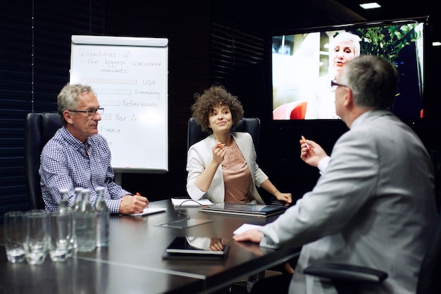 Photo business people having video conference at office