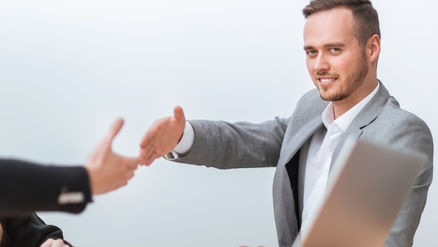 Business people holding out their hands for a handshake