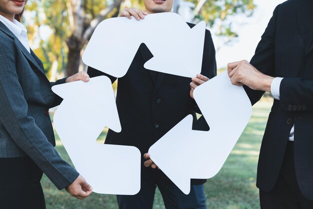 Photo business people holding pieces of reverse arrow icon into recycle symbol gyre