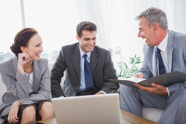 Business people laughing while having a meeting