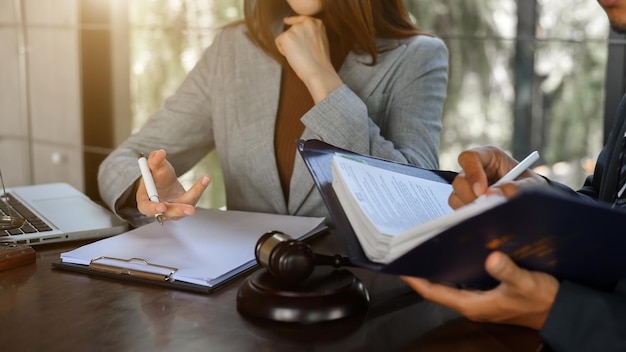 Business people and lawyers discussing contract papers sitting at the office table