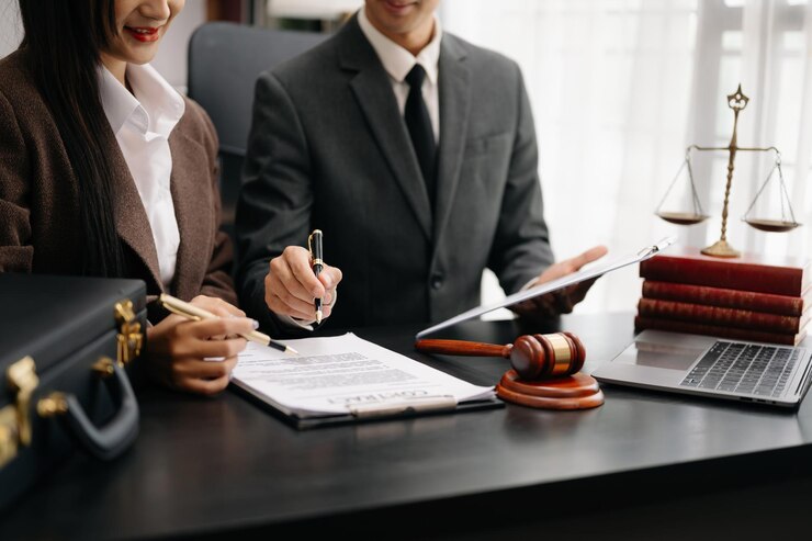 business people and lawyers discussing contract papers sitting at the table Concepts of law advice legal services in morning lightxA