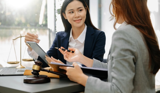 Photo business people and lawyers discussing contract papers sitting at the table concepts of law advice legal services