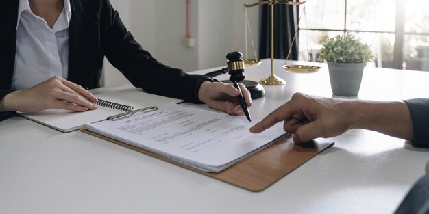 Business people and lawyers discussing contract papers sitting at the table Concepts of law advice legal services